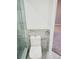 New toilet with covered seat is installed next to the modern glass-enclosed shower stall at 1041 Kennesborough Nw Rd, Kennesaw, GA 30144