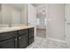 Bathroom with patterned floor and dark vanity at 4010 Village Run Dr, Mcdonough, GA 30252