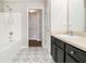 Bathroom with patterned floor, bathtub, and dark vanity at 4010 Village Run Dr, Mcdonough, GA 30252