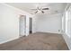 Bright bedroom with carpet, ceiling fan, and two windows at 4010 Village Run Dr, Mcdonough, GA 30252