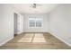 Bright bedroom with wood-look floors and ceiling fan at 4010 Village Run Dr, Mcdonough, GA 30252