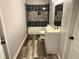 Updated bathroom with modern fixtures and stone tile at 781 Peyton Nw Ave, Atlanta, GA 30318