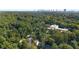 An aerial view of a beautiful home and neighborhood with a city skyline in the distance at 2493 Oldfield Nw Rd, Atlanta, GA 30327