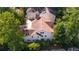 An aerial backyard view showcasing trees and a home with neutral colors at 2493 Oldfield Nw Rd, Atlanta, GA 30327