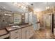 Bright bathroom featuring double vanity with granite countertops, patterned wallpaper, and tiled floors at 2493 Oldfield Nw Rd, Atlanta, GA 30327