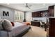 Bedroom with blue walls, ceiling fan, window with shutters, built-in desk, and carpet flooring at 2493 Oldfield Nw Rd, Atlanta, GA 30327