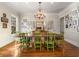 Traditional dining room showcasing a grand chandelier and walls adorned with framed photos at 2493 Oldfield Nw Rd, Atlanta, GA 30327