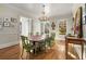 Bright dining room with hardwood floors, chandelier, and views of the outside at 2493 Oldfield Nw Rd, Atlanta, GA 30327