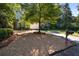 Charming home featuring lush landscaping and well-maintained gravel driveway and address post at 2493 Oldfield Nw Rd, Atlanta, GA 30327