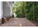 A gravel area provides extra space and is surrounded by mature trees at 2493 Oldfield Nw Rd, Atlanta, GA 30327