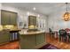 A cozy kitchen featuring granite countertops, stainless appliances, and custom cabinets, all illuminated by modern pendant lighting at 2493 Oldfield Nw Rd, Atlanta, GA 30327