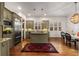 A chef-inspired kitchen with stainless steel appliances, granite counters, an island cooktop, and hardwood floors at 2493 Oldfield Nw Rd, Atlanta, GA 30327