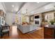 Spacious living room with hardwood floors, a stone fireplace, and a comfortable gray sofa under a modern chandelier at 2493 Oldfield Nw Rd, Atlanta, GA 30327