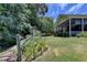 Landscaped backyard with lush greenery and wooden fence at 3550 Rivers End Pl, Buford, GA 30519