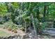 Landscaped backyard with lush greenery and wooden fence at 3550 Rivers End Pl, Buford, GA 30519