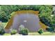 Aerial view of a serene pond with a fountain at 3550 Rivers End Pl, Buford, GA 30519
