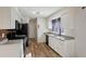 Modern kitchen with granite counters, white cabinets, and stainless steel appliances at 158 Ashwood Ct, Riverdale, GA 30274