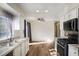 Galley kitchen with granite counters, white cabinets and stainless steel appliances at 158 Ashwood Ct, Riverdale, GA 30274