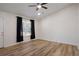 Spacious living room featuring wood-look floors and a ceiling fan at 158 Ashwood Ct, Riverdale, GA 30274