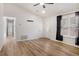 Open living room with wood-look floors and access to hallway at 158 Ashwood Ct, Riverdale, GA 30274