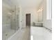Modern bathroom showcasing a glass-enclosed shower, freestanding tub, and neutral color palette at 4455 Ryker Rd, Cumming, GA 30041