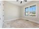 Bedroom with large window with front yard view and white trim at 4455 Ryker Rd, Cumming, GA 30041