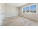 Bedroom with a large window providing natural light, neutral walls, and white trim at 4455 Ryker Rd, Cumming, GA 30041