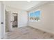 Bedroom featuring neutral walls, bright window view, and a glimpse into the ensuite bathroom at 4455 Ryker Rd, Cumming, GA 30041