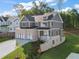 Side view of a new home featuring brick and gray siding, manicured front lawn and three-car garage at 4455 Ryker Rd, Cumming, GA 30041