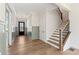 Sun-drenched foyer featuring hardwood floors, wainscoting and staircase with iron balusters at 4455 Ryker Rd, Cumming, GA 30041