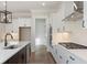 A modern kitchen features white cabinets, stainless steel appliances, and quartz countertops at 4455 Ryker Rd, Cumming, GA 30041