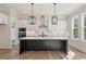 Modern kitchen with a large black island, stainless steel appliances, and pendant lighting at 4455 Ryker Rd, Cumming, GA 30041