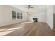 Bright living room featuring hardwood floors, fireplace and multiple windows at 4455 Ryker Rd, Cumming, GA 30041