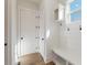 Bright mudroom with built-in bench seating, coat hooks, and storage shelves for organization at 4455 Ryker Rd, Cumming, GA 30041