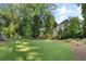 Landscaped backyard with lush greenery and lawn at 1095 Curry Dr, Atlanta, GA 30319