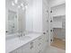 Modern bathroom with white cabinets, quartz countertops, and an adjacent closet at 1095 Curry Dr, Atlanta, GA 30319