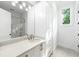 Bright bathroom with white cabinets, quartz countertop, and a walk-in shower at 1095 Curry Dr, Atlanta, GA 30319