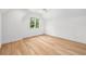 Spacious bedroom featuring light hardwood floors and a large window at 1095 Curry Dr, Atlanta, GA 30319