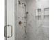 Large walk-in shower with marble tile and multiple shower heads at 1095 Curry Dr, Atlanta, GA 30319