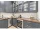 Elegant wet bar with wine cooler and gray cabinetry at 1095 Curry Dr, Atlanta, GA 30319