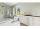 Modern bathroom with a glass-enclosed shower, tile flooring, and custom cabinetry at 825 Kenry Ct, Atlanta, GA 30342