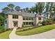 Beautiful stone home featuring manicured landscaping, gray shingles, and modern windows at 825 Kenry Ct, Atlanta, GA 30342