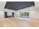 Large living room with a dark ceiling, hardwood floors, recessed lighting, and access to the pool at 825 Kenry Ct, Atlanta, GA 30342