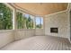 Covered porch features a fireplace with views of the wooded backyard at 825 Kenry Ct, Atlanta, GA 30342