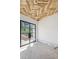 Unfinished room featuring Herringbone patterned ceiling and black framed glass doors at 825 Kenry Ct, Atlanta, GA 30342