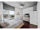 Modern bedroom features exposed concrete ceilings, dark wood floors, and a stunning city view from a large window at 3324 Peachtree Ne Rd # 2718, Atlanta, GA 30326