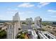 Elevated view of the city showcasing modern architecture and lush greenery at 3324 Peachtree Ne Rd # 2718, Atlanta, GA 30326
