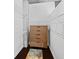 Walk-in closet features custom shelving, a wooden dresser, and dark wood floors at 3324 Peachtree Ne Rd # 2718, Atlanta, GA 30326