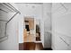 Walk-in closet with metal shelves and dark wood floors leading into bathroom at 3324 Peachtree Ne Rd # 2718, Atlanta, GA 30326