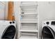 Laundry room area featuring white shelving, a washer and dryer at 3324 Peachtree Ne Rd # 2718, Atlanta, GA 30326